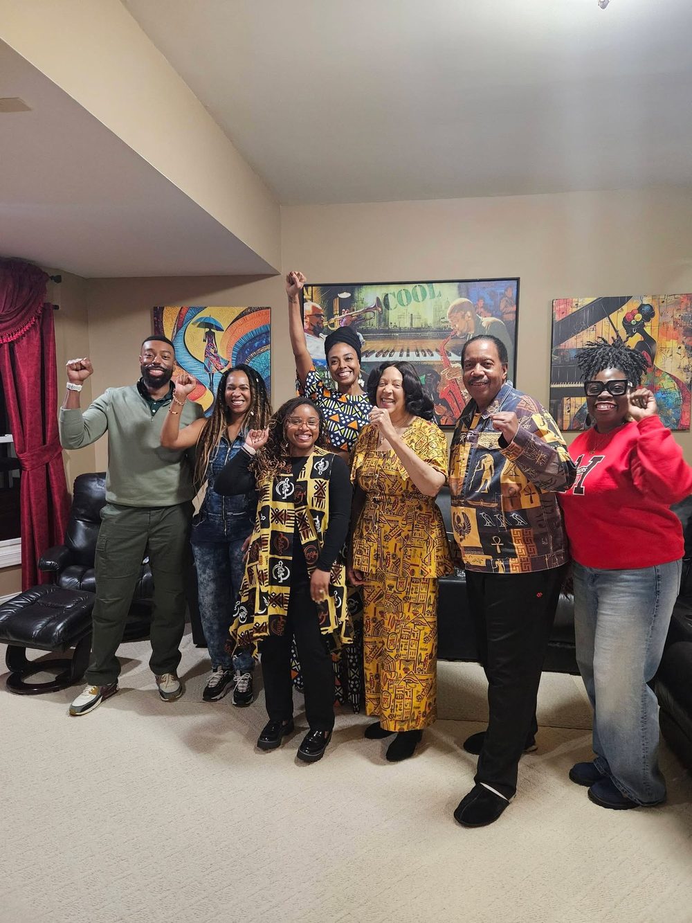 MAABPsi members raising fists together at the December celebration