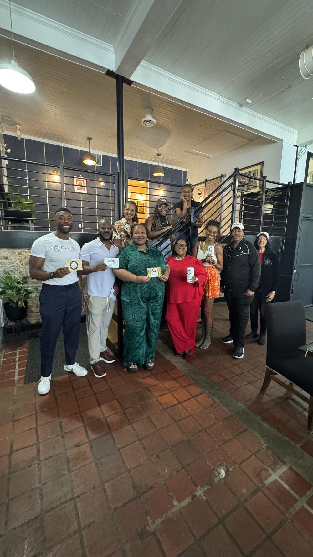 Members holding MAABPsi cards and mugs at a chapter gathering